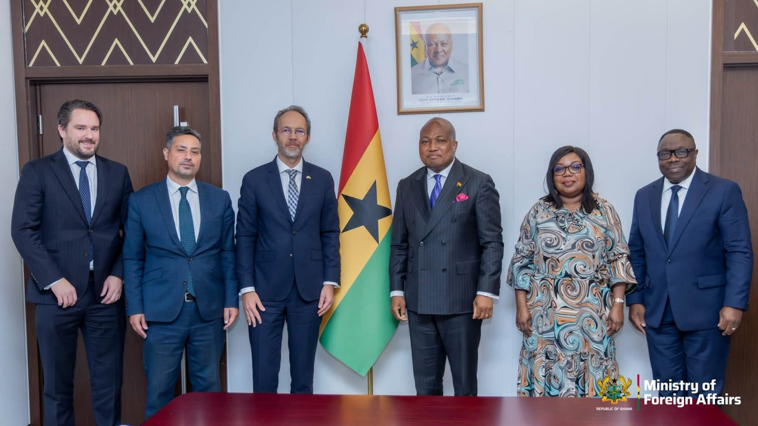 Samuel Okudzeto Ablakwa and Christian Rogg with their teams beside a Ghana flag