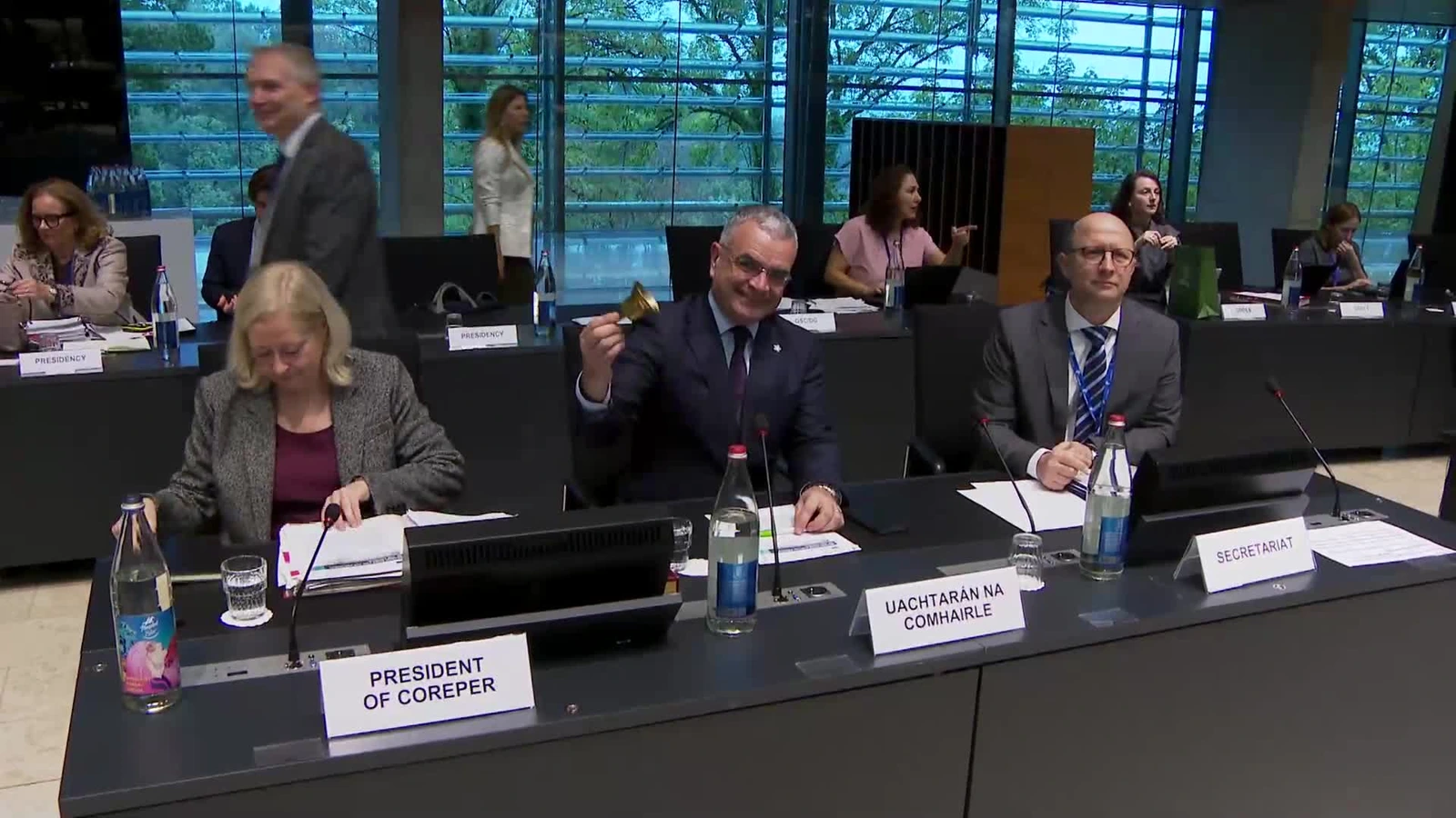 Participants seated at the Council meeting in Luxembourg, with the chair holding a bell.