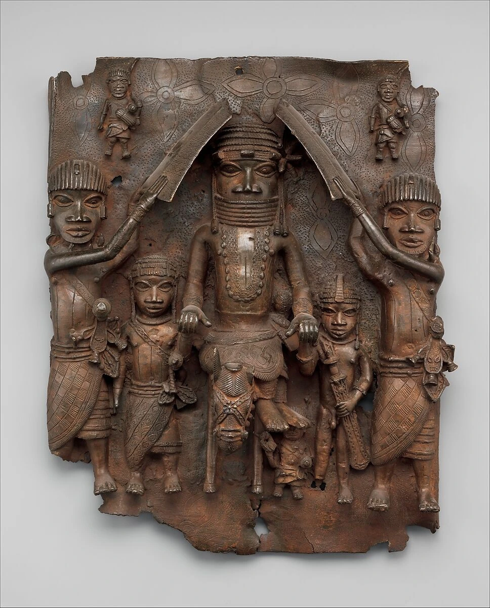 A brass plaque shows a centrally placed mounted king with attendants of different sizes.
