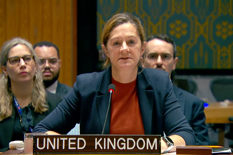 Kate Foster seated behind the United Kingdom placard while speaking at the UN Security Council.